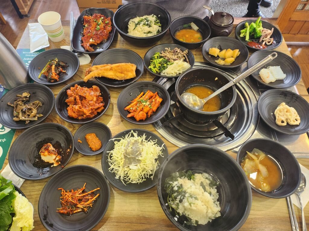 Korean breakfast spread with rice, soup, kimchi and side dishes